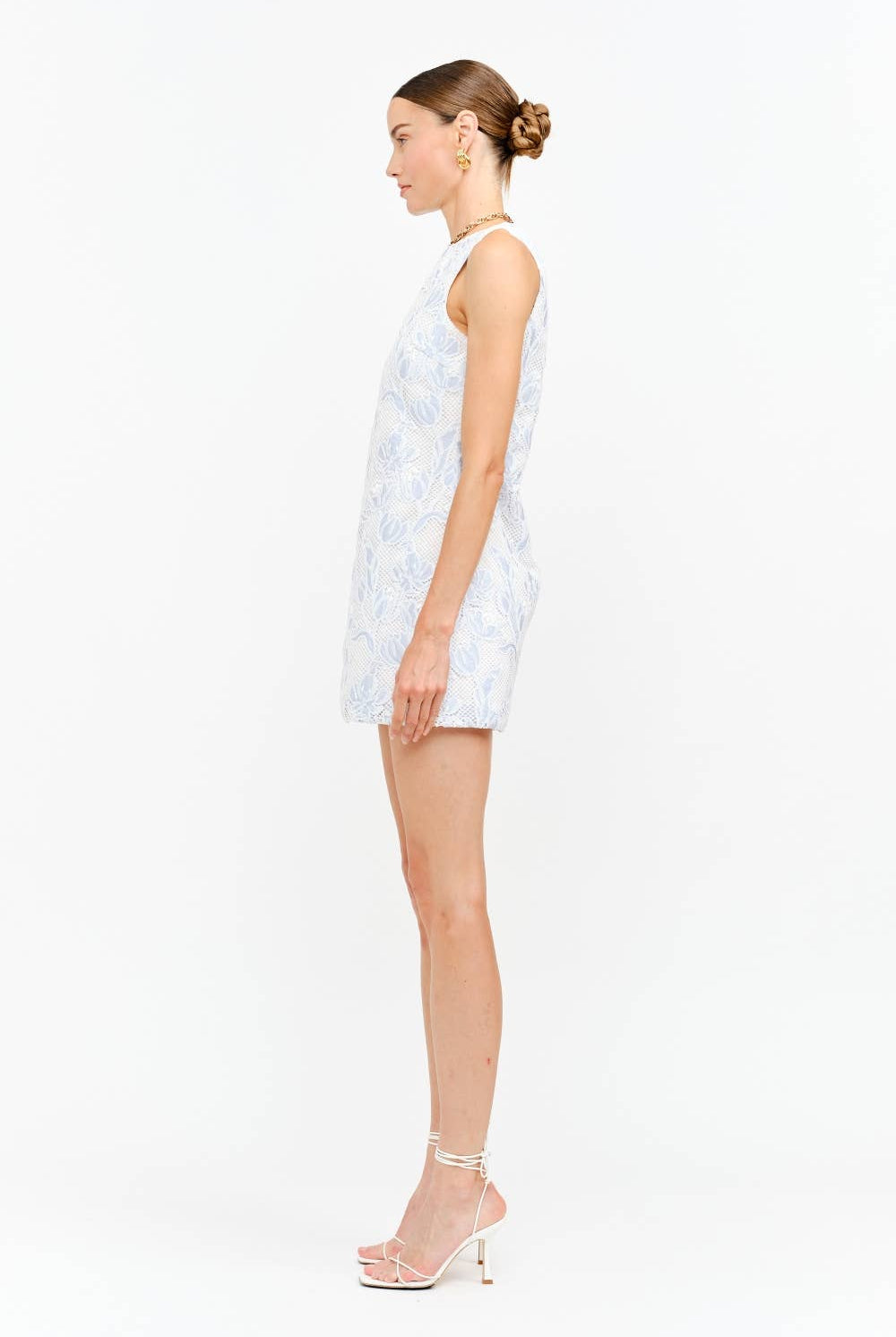 Woman wearing blue floral lace sleeveless dress