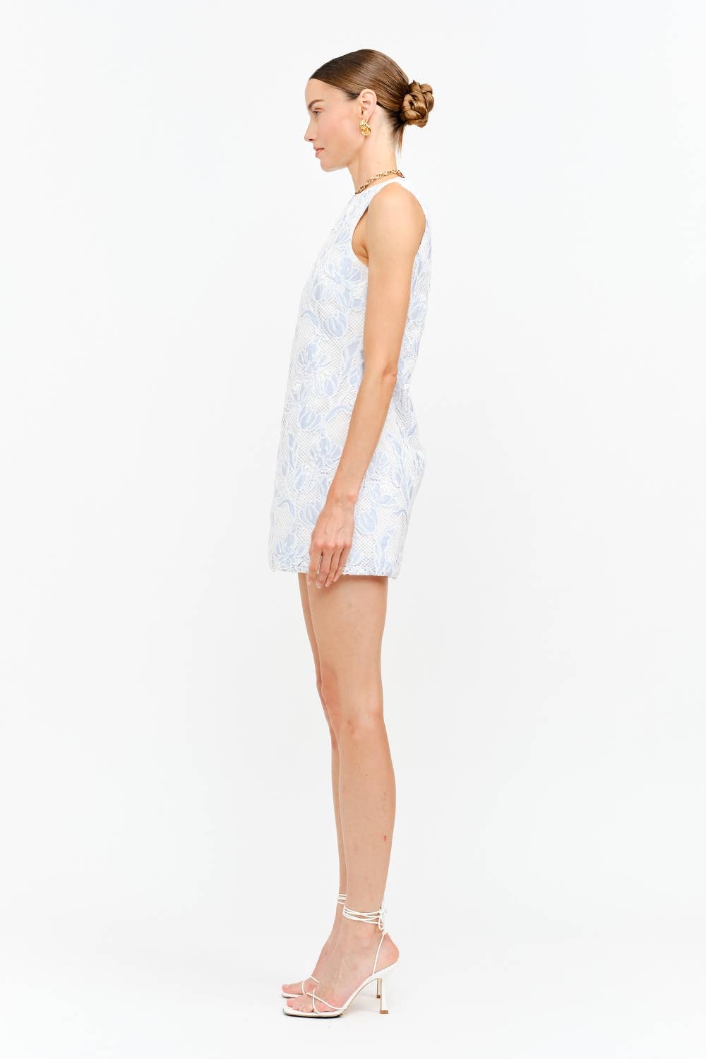 Woman wearing blue floral lace sleeveless dress