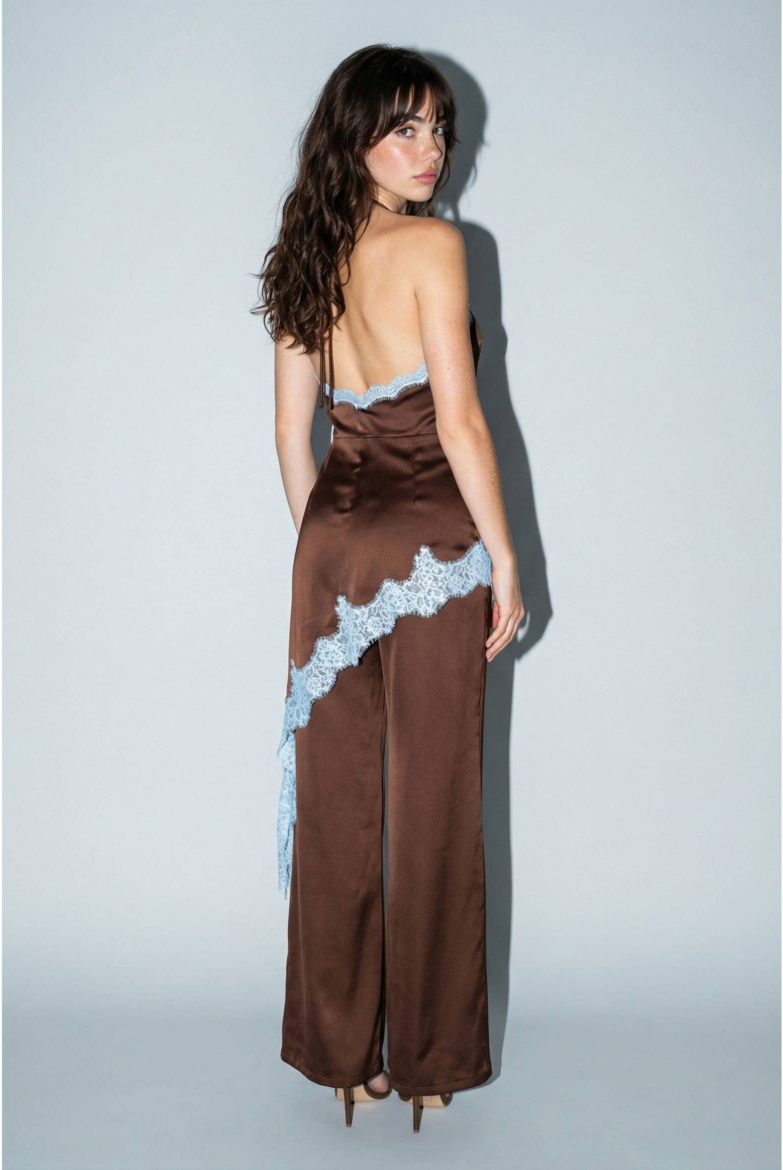 Brown satin halter jumpsuit styled for a party or evening event, wide-leg detail