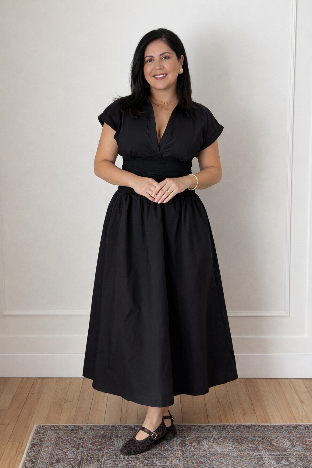 black midi dress with v-necklines and cinched waits.