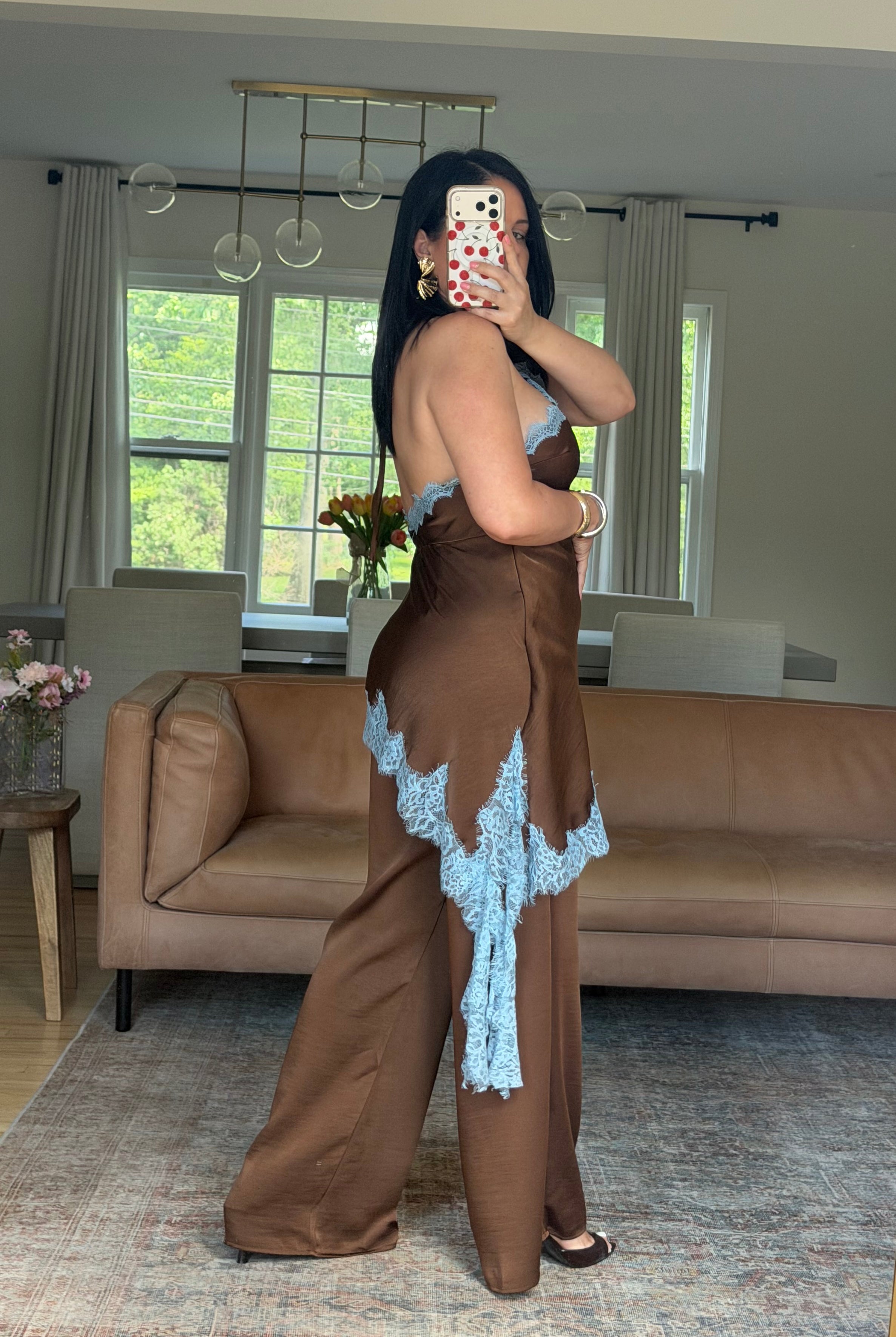 Lace trim halter jumpsuit in chocolate brown satin, side view showing wide-leg fit