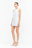 Woman wearing a blue floral  sleeveless mini dress
