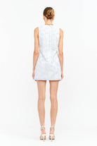 Woman wearing a  blue floral lace sleeveless mini dress 