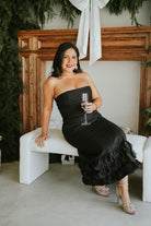 Woman in a black strapless dress 