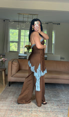 Lace trim halter jumpsuit in chocolate brown satin, side view showing wide-leg fit