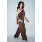 Close-up of asymmetrical lace applique on chocolate brown satin jumpsuit
